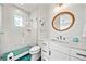 Modern bathroom with white vanity and herringbone tile shower at 2213 Avenue B, Bradenton Beach, FL 34217