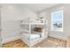 Charming bedroom with a white bunk bed and window seat at 2213 Avenue B, Bradenton Beach, FL 34217