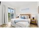 Bedroom with king-size bed and access to a private balcony at 2213 Avenue B, Bradenton Beach, FL 34217