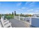 Relaxing rooftop deck with white rocking chairs and neighborhood views at 2213 Avenue B, Bradenton Beach, FL 34217