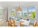 Bright dining area with white table, teal accents, and large windows at 2213 Avenue B, Bradenton Beach, FL 34217