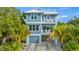 Two-story home with light blue siding, two balconies, and a two-car garage at 2213 Avenue B, Bradenton Beach, FL 34217