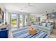 Bright living room with blue sofa and access to a balcony at 2213 Avenue B, Bradenton Beach, FL 34217