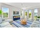 Relaxing living room with light sofas, blue and white rug, and access to balcony at 2213 Avenue B, Bradenton Beach, FL 34217