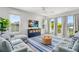 Light-filled living area featuring comfortable sofas and a large TV at 2213 Avenue B, Bradenton Beach, FL 34217