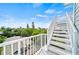 White stairs leading up to a balcony overlooking the neighborhood at 2213 Avenue B, Bradenton Beach, FL 34217