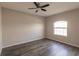 Spacious bedroom with wood-look flooring and large window at 22419 Bette Ave, Port Charlotte, FL 33954