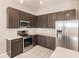 Modern kitchen with dark cabinets and stainless steel appliances at 22419 Bette Ave, Port Charlotte, FL 33954