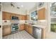 Bright kitchen with stainless steel appliances and light wood cabinets at 227 Saint James Park, Osprey, FL 34229