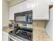 Modern kitchen with stainless steel appliances and granite countertops at 2400 Feather Sound Dr # 215, Clearwater, FL 33762