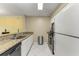 Galley-style kitchen with granite countertops and stainless steel appliances at 2400 Feather Sound Dr # 215, Clearwater, FL 33762