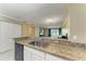 Kitchen features granite countertops and a breakfast bar at 2400 Feather Sound Dr # 215, Clearwater, FL 33762