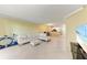 Spacious living area with white L-shaped sofa and view into kitchen at 2400 Feather Sound Dr # 215, Clearwater, FL 33762