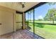 Screened porch with golf course view and tiled floor at 2400 Feather Sound Dr # 215, Clearwater, FL 33762