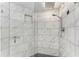 Modern shower with marble tile and glass enclosure at 2400 Feather Sound Dr # 215, Clearwater, FL 33762