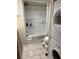 Bathroom with tub, toilet, and stacked washer/dryer at 2601 Gulf N Dr # S2, Bradenton Beach, FL 34217