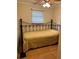 Bedroom with metal frame bed, window, and light at 2601 Gulf N Dr # S2, Bradenton Beach, FL 34217