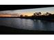 Scenic sunset view over lake with lush green vegetation and houses at 3001 Seasons Blvd, Sarasota, FL 34240