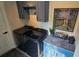 Modern laundry room with black LG washer and dryer, blue cabinets, and stylish decor at 3001 Seasons Blvd, Sarasota, FL 34240