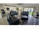 Bright living area with leather sofas and a view into the kitchen and patio at 3001 Seasons Blvd, Sarasota, FL 34240