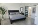 Main bedroom with modern dresser and sliding barn door to bathroom at 3001 Seasons Blvd, Sarasota, FL 34240