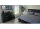 Spacious bedroom with large bed, dresser and plant at 3001 Seasons Blvd, Sarasota, FL 34240