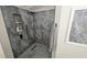 Walk-in shower with gray tile and built-in shelving at 3001 Seasons Blvd, Sarasota, FL 34240