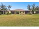 Home with a large backyard, screened patio, and lush grass at 314 Mystic Falls Dr, Apollo Beach, FL 33572