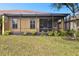 Home exterior showcasing a large backyard with a screened patio at 314 Mystic Falls Dr, Apollo Beach, FL 33572