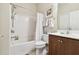 Bright bathroom featuring a shower/tub combo and wood vanity at 314 Mystic Falls Dr, Apollo Beach, FL 33572