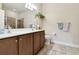 Double vanity bathroom with a large mirror and walk-in shower at 314 Mystic Falls Dr, Apollo Beach, FL 33572