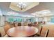 Large community room with round tables and chairs at 314 Mystic Falls Dr, Apollo Beach, FL 33572