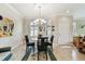 Bright dining room with a round table, chandelier, and bay window at 314 Mystic Falls Dr, Apollo Beach, FL 33572