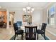 Bright dining room features a round table with four chairs and a view into the kitchen at 314 Mystic Falls Dr, Apollo Beach, FL 33572