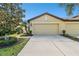 View of a house's side elevation, highlighting the garage and landscaping at 314 Mystic Falls Dr, Apollo Beach, FL 33572