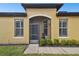 Front entrance with a screened porch and nicely manicured hedges at 314 Mystic Falls Dr, Apollo Beach, FL 33572