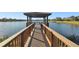 Wooden walkway to gazebo over lake at 314 Mystic Falls Dr, Apollo Beach, FL 33572