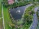 Quaint pond with central fountain and greenery at 314 Mystic Falls Dr, Apollo Beach, FL 33572