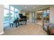 Grand piano in a music room with large windows at 340 S Palm Ave # 45, Sarasota, FL 34236