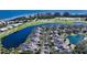 Aerial view showcasing a community of homes near a golf course and body of water at 3465 Winding Oaks Dr # 33, Longboat Key, FL 34228