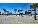 Beachfront view of cabanas and palm trees at 3465 Winding Oaks Dr # 33, Longboat Key, FL 34228