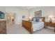 Primary bedroom with king-size bed and views of the hallway and other rooms at 3465 Winding Oaks Dr # 33, Longboat Key, FL 34228