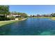 Scenic lake view with lush landscaping and a gazebo at 3465 Winding Oaks Dr # 33, Longboat Key, FL 34228