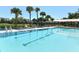 Inviting community pool with lounge chairs and shade at 3465 Winding Oaks Dr # 33, Longboat Key, FL 34228