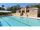 Community lap pool with adjacent seating and shade structure at 3465 Winding Oaks Dr # 33, Longboat Key, FL 34228