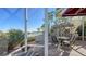 Relaxing screened patio with table and chairs, overlooking a tranquil lagoon at 3465 Winding Oaks Dr # 33, Longboat Key, FL 34228