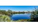 Calm waterfront view showcasing community homes at 3465 Winding Oaks Dr # 33, Longboat Key, FL 34228