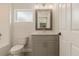 Modern gray vanity with a quartz countertop, toilet and bathtub at 3623 Giblin Dr, North Port, FL 34286