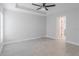 Spacious bedroom with neutral walls, tile floors, and ceiling fan at 3623 Giblin Dr, North Port, FL 34286