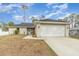 Single-story home with a two-car garage and landscaped front yard at 3623 Giblin Dr, North Port, FL 34286